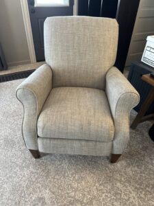 A clean upholstered armchair on a freshly cleaned carpet by Fiber Dry Carpet & Upholstery Cleaning in Dayton, OH.