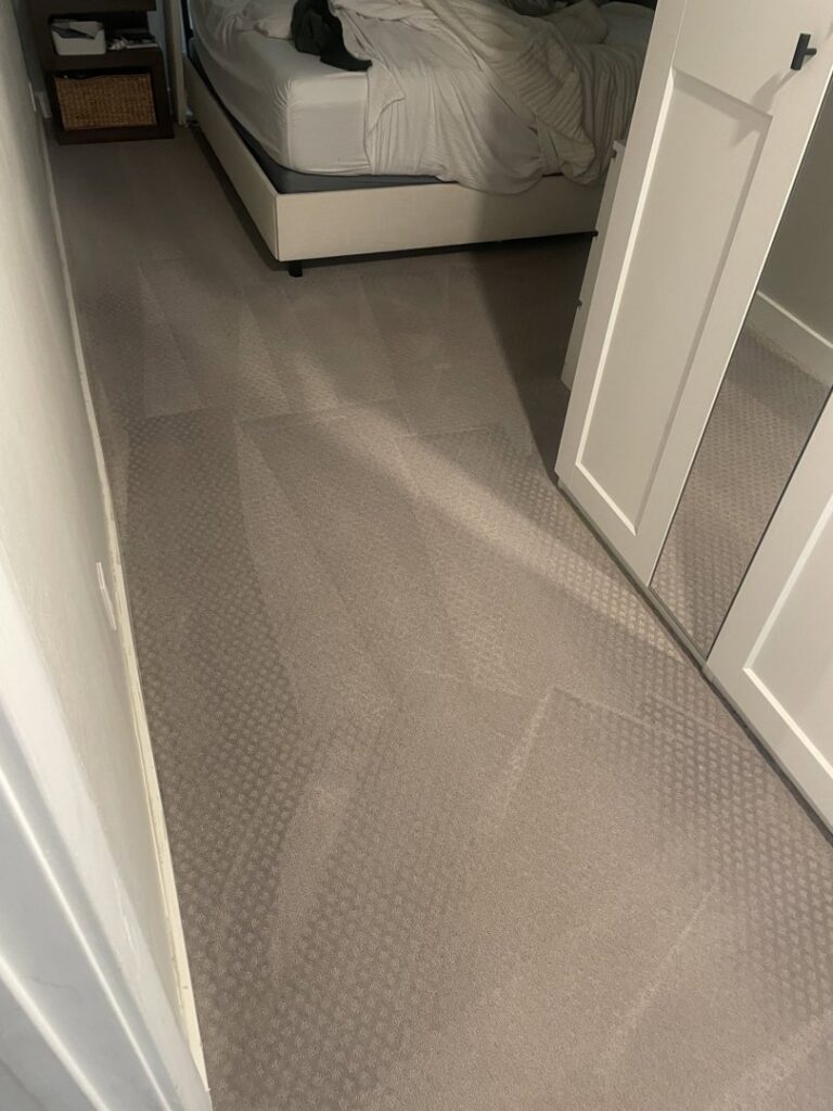 A clean bedroom carpet showing fresh vacuum lines after professional cleaning by Carpet Kingz in Houston, TX