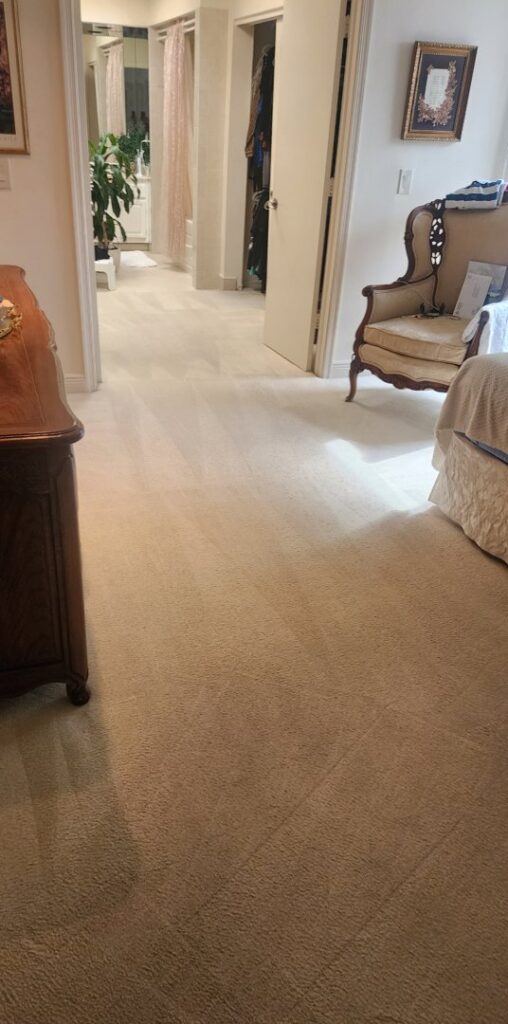 A clean, light-colored carpet with distinct vacuum lines in a bedroom, cleaned by Healthy Homes Cleaning and Restoration LLC in Fort Lauderdale, FL.