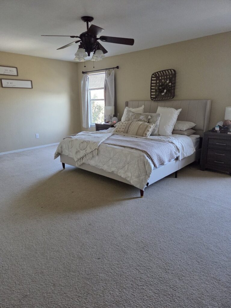 A clean, light-colored carpet in a bedroom, showcasing the results of Master's Touch Steam Cleaning in San Antonio, TX.