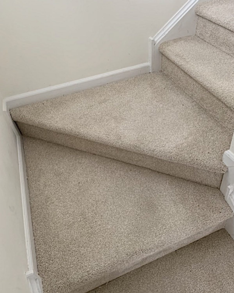 A clean, light beige carpet installed on a stair landing and steps by GC&D Flooring in Allentown, PA.