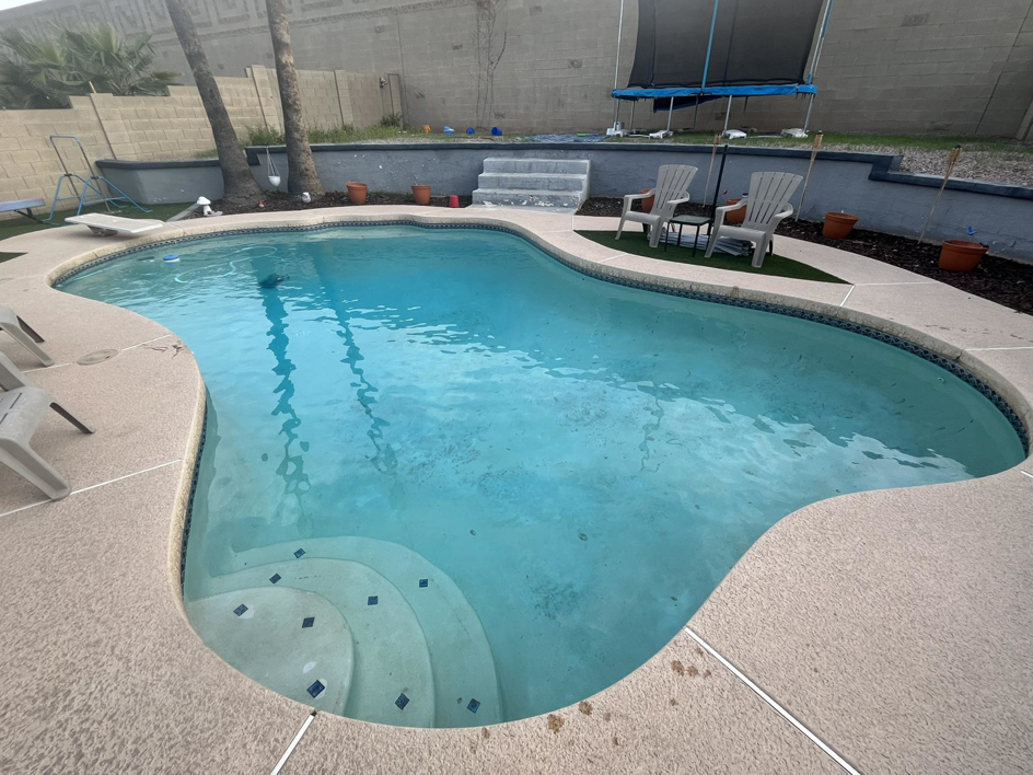 A beautifully clean and blue swimming pool, showcasing the excellent results from Brigade Pool Services in Tempe, AZ.