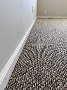 A clean brown carpet with visible cleaning lines in a room with light green walls by Hampton Carpet Cleaning Pros in Hampton, VA.