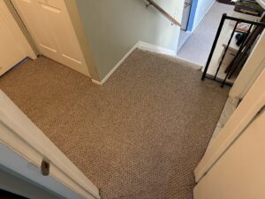 A clean brown carpet on stairs and a landing after service by Dry Green Cleaning in Detroit, MI.