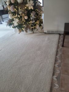 A clean, plush carpet around a Christmas tree after professional cleaning by Leo's Carpet Cleaning in Omaha, NE