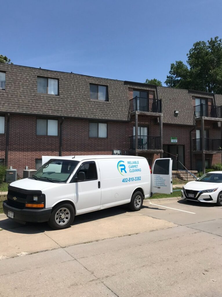 A clean carpet with distinct cleaning lines in a room with a sliding door to a balcony, by Reliable Carpet Cleaning LLC in Liverpool, NY.
