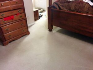 A clean, light-colored carpet in a bedroom after professional service by All Dimension Floor Care in Lenexa, KS.