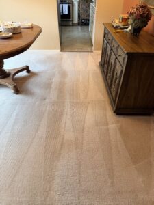 A freshly cleaned carpet in a dining area, showcasing the results of KD Carpet Cleaning in Albuquerque, NM.