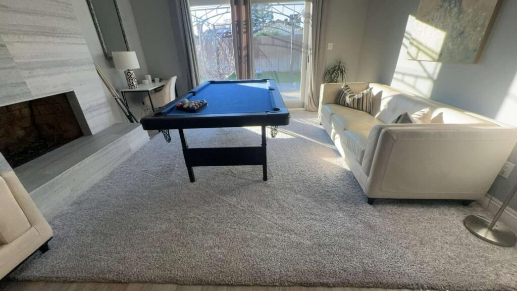Freshly cleaned carpet in a game room with a pool table by Central California King of Clean LLC in Bakersfield, CA.