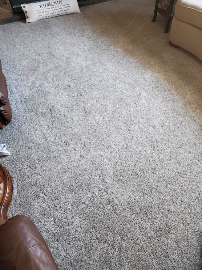 A clean, light gray carpet in a living room, showcasing quality work from Carpet Center Huron SD in Huron, SD.
