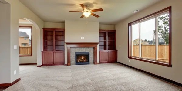 A spacious living room featuring a clean, light-colored carpet, demonstrating the quality work of Carpets Dirty in Phoenix, AZ