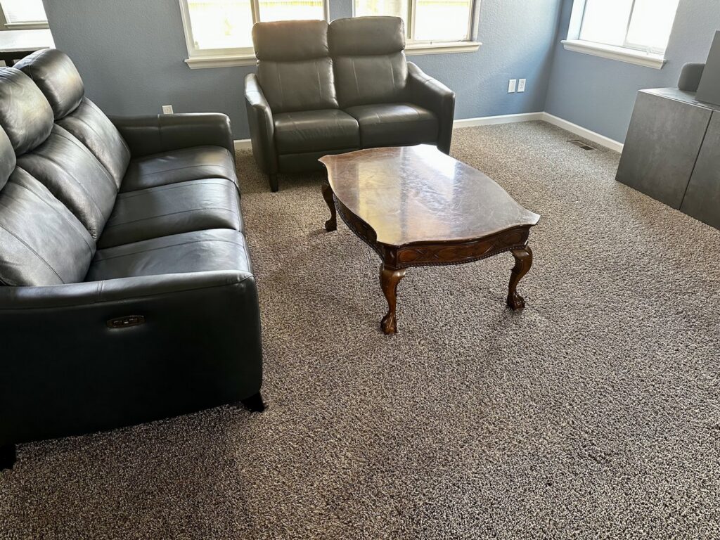 A freshly cleaned dark grey carpet in a living room after service by STC Carpet Care in Arvada, CO