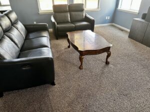 A freshly cleaned dark grey carpet in a living room after service by STC Carpet Care in Arvada, CO