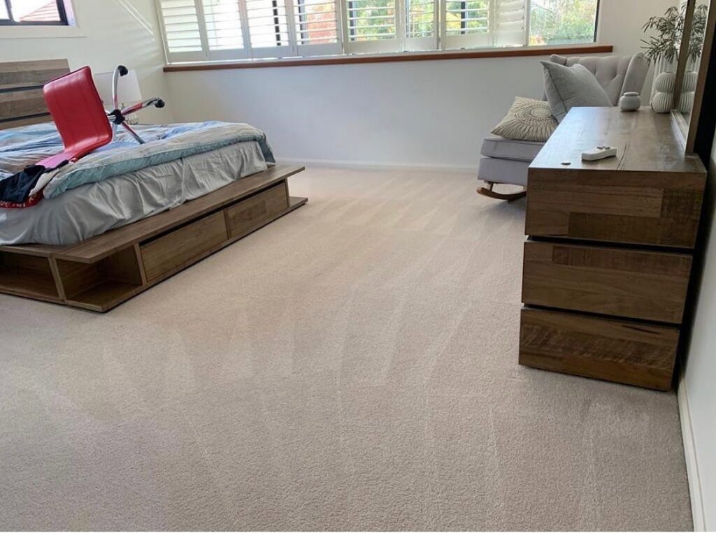 A clean, light-colored carpet in a modern bedroom after professional service by LS Upstate Cleaning in Greenville, SC.