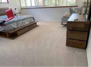 A clean, light-colored carpet in a modern bedroom after professional service by LS Upstate Cleaning in Greenville, SC.