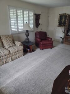 A clean, light-colored carpet in a residential living room after professional cleaning by STC Carpet Care in Arvada, CO