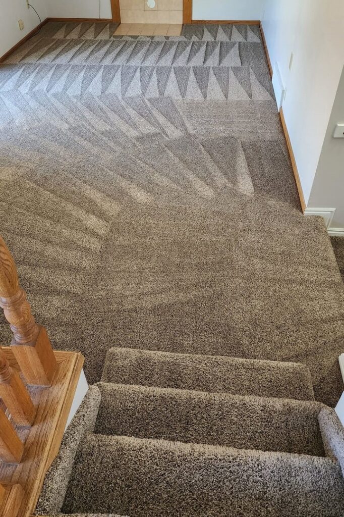 A freshly cleaned carpeted staircase and hallway with visible cleaning lines by JP Carpet & Tile Care in Sherman Oaks, CA.