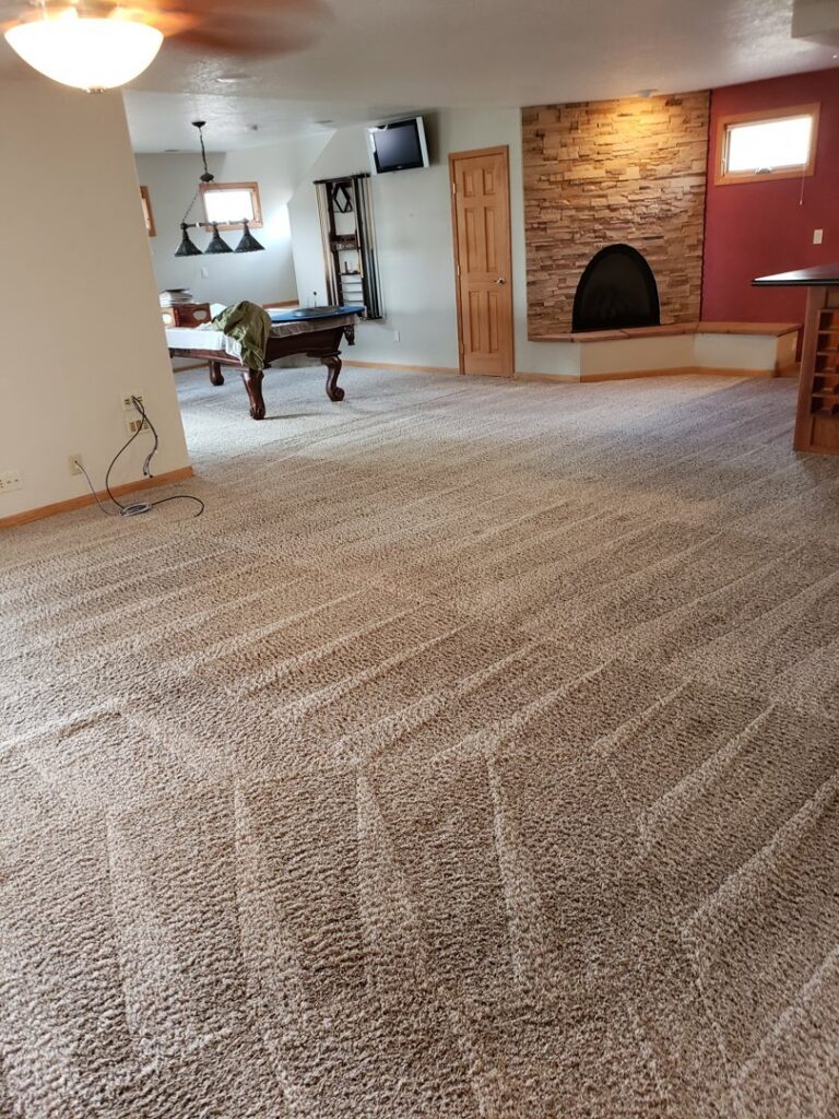 A clean, light-colored carpet showing diagonal cleaning lines in a room by Steamaway Carpet Cleaning in Albuquerque, NM.