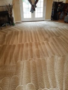 A clean carpet with distinct cleaning patterns in a living room after service by Affordable carpet cleaning CO LLC in Montgomery, AL.