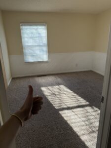 A clean carpet in a room with a satisfied customer's thumbs-up gesture for PRIME CLEAN VA in Virginia Beach, VA.