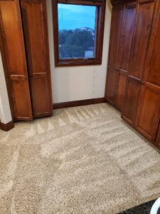 A room with clean carpet showing fresh vacuum lines after service by Pueblo's Best Carpet & Air Duct Cleaning in Pueblo West, CO.