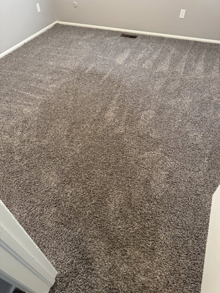 A clean carpeted bedroom showing professional cleaning results from Hill's Magic Carpet Cleaning in Colorado Springs, CO.