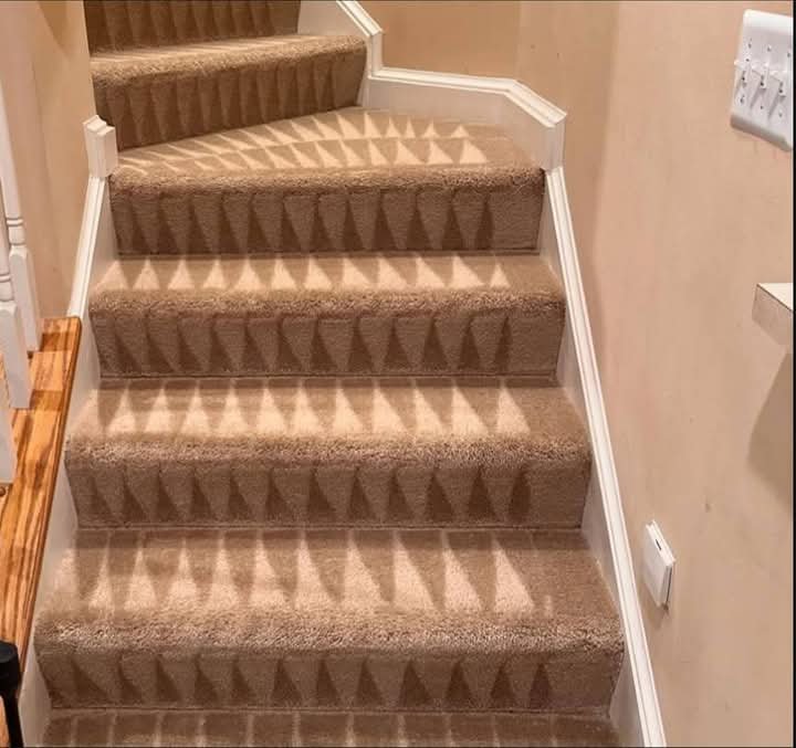 A clean, freshly serviced carpeted staircase with visible cleaning lines by Just Right Carpet Cleaning of Goose creek moncks corner in North Charleston, SC.