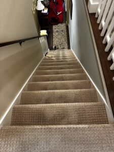 A clean, well-maintained carpeted staircase in a home, serviced by KODA Carpet Cleaning in Holland, MI.