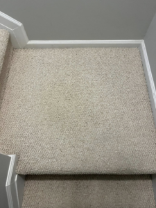A clean, light-colored carpeted staircase landing, showcasing the results of JDog Carpet Cleaning & Floor Care Alpharetta in Roswell, GA.
