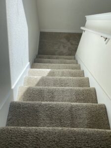 Clean, plush carpeted stairs, demonstrating professional results from Master's Touch Steam Cleaning in San Antonio, TX.