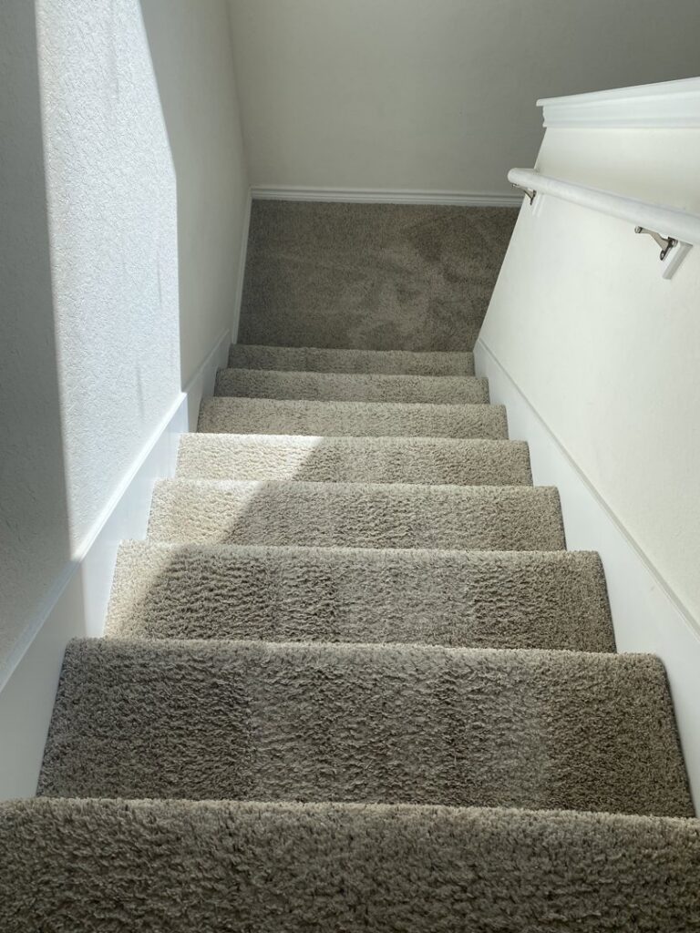 Clean, plush carpeted stairs, demonstrating professional results from Master's Touch Steam Cleaning in San Antonio, TX.