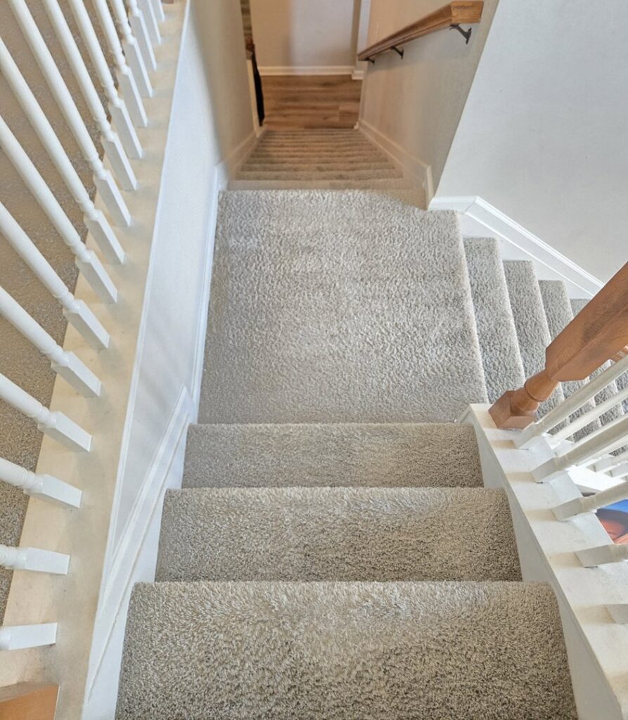 Clean, light-colored carpeted stairs in a residential home, professionally serviced by Carpet Cleaning & More in Atlanta, GA.