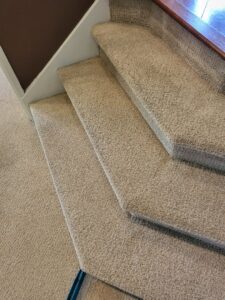 Clean, light-colored carpet installed on a residential staircase by Greenco2 in Grand Rapids, MI.