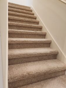 Cleaned carpeted stairs with visible cleaning patterns by Reynolds Carpet Care in Henrico, VA.