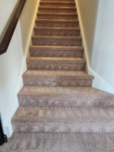 Clean brown carpeted stairs after professional cleaning by Roberts Cleaning Services in Zionsville, IN.