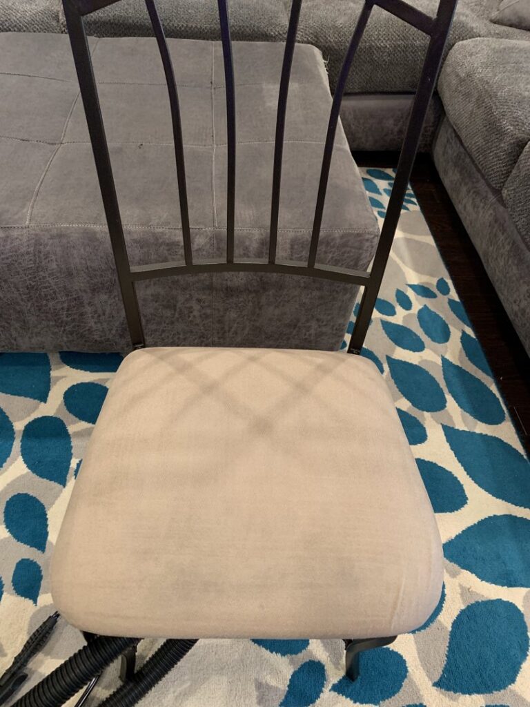 A clean chair cushion on a patterned rug after upholstery cleaning by Magic Clean Plus in Ann Arbor, MI.