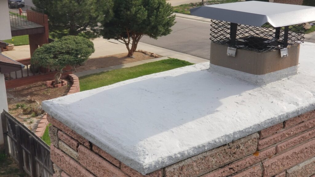 A clean chimney crown and cap on a residential chimney, serviced by Chimney Karma in Fort Collins, CO.