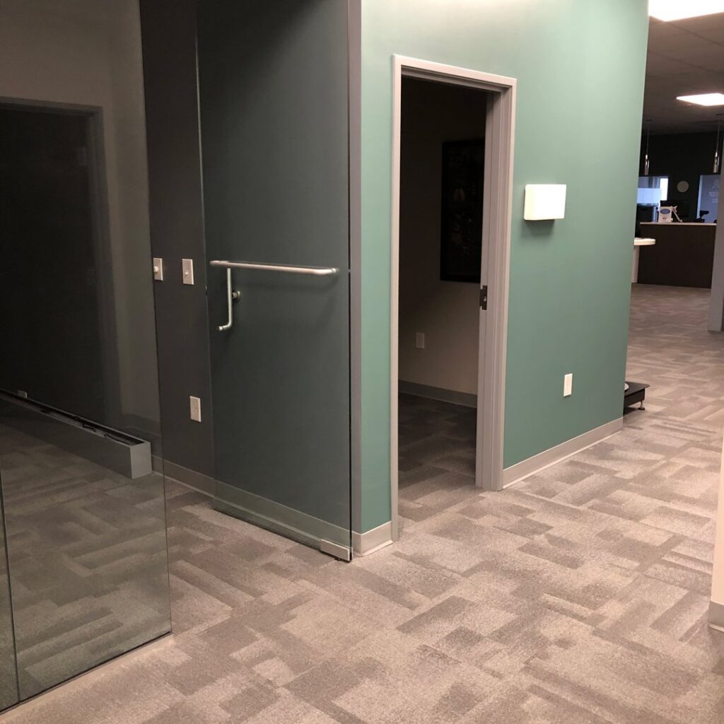 A clean, patterned carpet in a commercial office hallway, showcasing the quality work of Eco Carpet Cleaning in Indianapolis, IN.