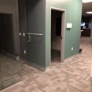 A clean, patterned carpet in a commercial office hallway, showcasing the quality work of Eco Carpet Cleaning in Indianapolis, IN.