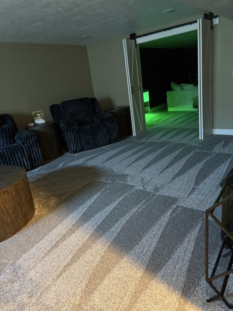 A room featuring freshly cleaned, dark grey patterned carpet with clear vacuum marks by 307 Spotless Solutions in Rock Springs, WY.