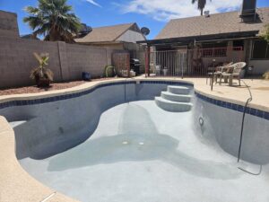 A clean, drained residential pool after a deep cleaning service by Vanguard Pool Care in Phoenix, AZ
