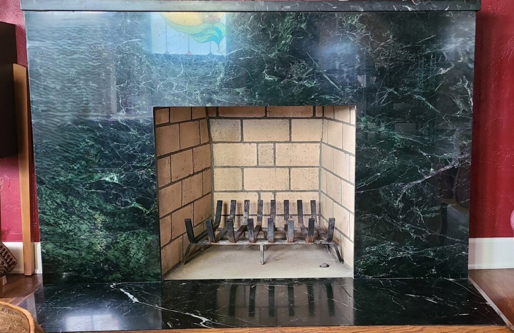 A clean fireplace interior with a metal grate, ready for use after service by Fireplace Freddie in Shadow Hills, CA.