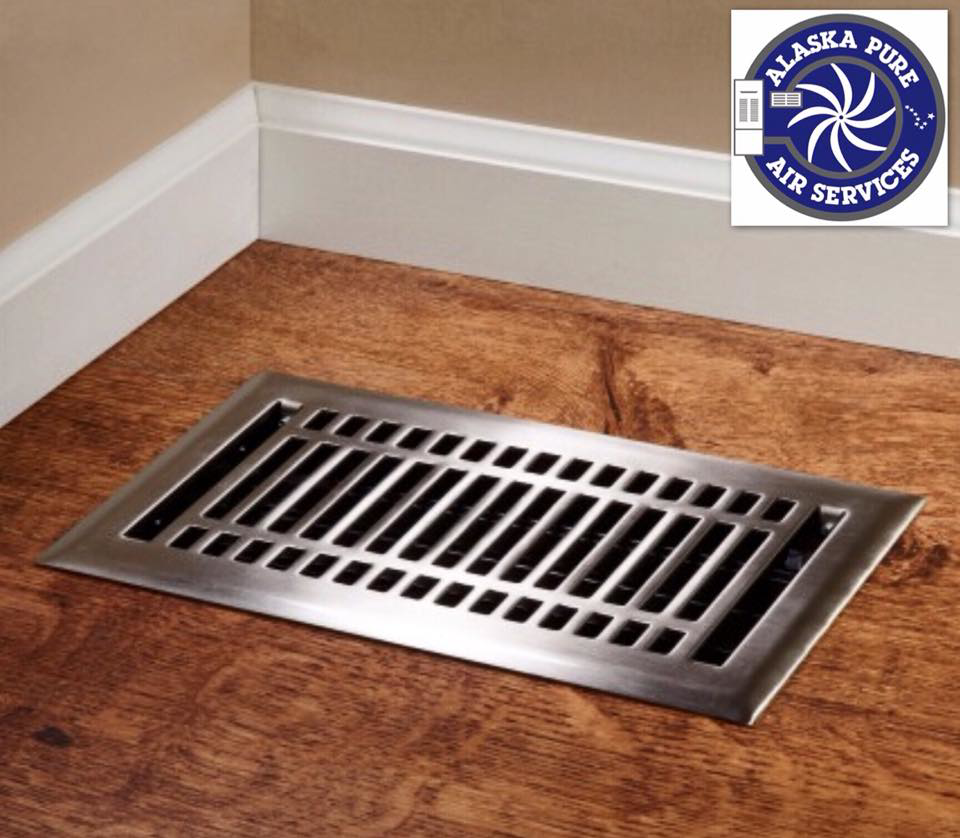 A clean floor air vent register on a wooden floor, representing air quality services by Alaska Pure Air Services in Anchorage, AK