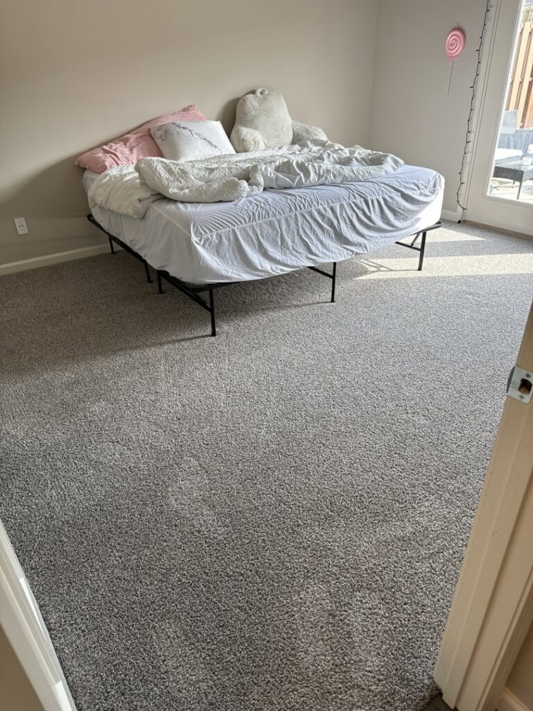 A clean grey carpet in a bedroom, showing the results of service by Safe-Dry Carpet Cleaning of Clarksville, TN