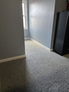 A clean grey carpet in a hallway, reflecting the professional service of Safe-Dry Carpet Cleaning of Clarksville, TN