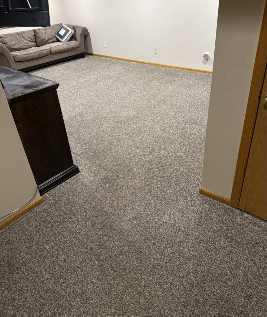 A clean, plush grey carpet in a room after professional cleaning by North Colorado Kwik Dry Total Cleaning in Johnstown, CO.