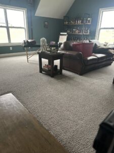 A clean grey carpet in a living area with furniture, demonstrating results from Safe-Dry Carpet Cleaning of Clarksville, TN