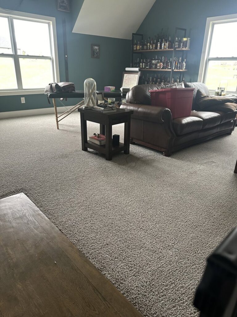 A clean grey carpet in a living area with furniture, demonstrating results from Safe-Dry Carpet Cleaning of Clarksville, TN