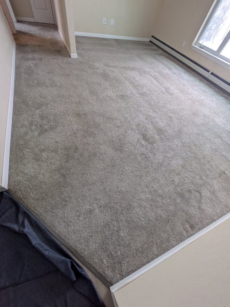A clean room with grey carpet, showcasing professional results from Alaska Floor Care Specialists in Fairbanks, AK.