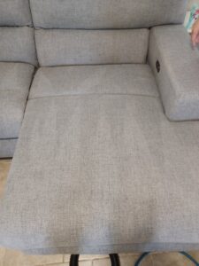 A clean section of a grey sectional sofa after professional upholstery cleaning by El Paso Carpet Care in El Paso, TX.